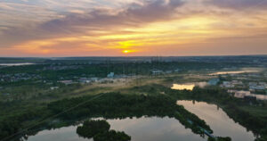 VIDEO Aerial drone view of a lake surrounded by trees in Chisinau, Moldova at sunrise - Starpik