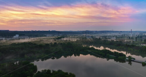 VIDEO Aerial drone view of a lake surrounded by trees in Chisinau, Moldova at sunrise - Starpik