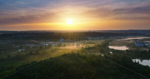 VIDEO Aerial drone view of a lake surrounded by trees in Chisinau, Moldova at sunrise - Starpik