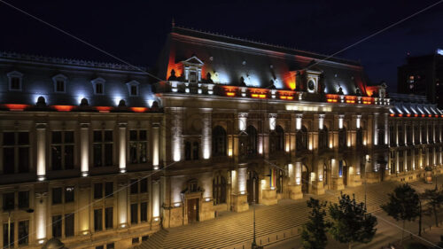 VIDEO Aerial drone view of the illuminated Palace of Justice in Bucharest, Romania, at night - Starpik