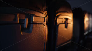 VIDEO Close up of black airplane seats in sunlight during a flight - Starpik