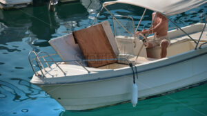 Royalty free stock footage Man moving in boat in the Port Vauban in Antibes, France - Starpik