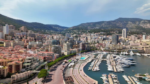 Royalty free stock video Aerial view of white boats docked in the Monaco Marina with the skyline on the background - Starpik