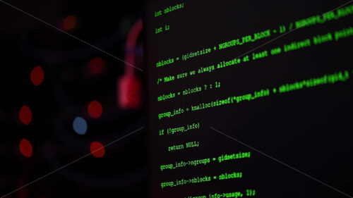 Royalty free stock video Close up of code on a screen in a server room with flashing red lights - Starpik