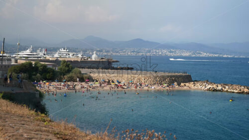 Royalty free stock video People swimming in the sea and relaxing on the beach in Antibes, France - Starpik