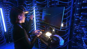 Royalty free stock video Woman programming in a server room while a man is using a Virtual Reality headset - Starpik