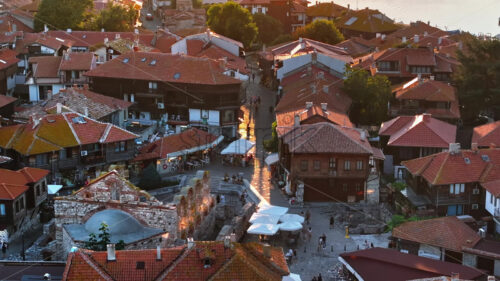 Royalty free video Aerial drone view of people moving through the old town Nessebar, Bulgaria at sunset - Starpik