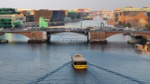 Video Aerial drone view of a yellow boat moving on the water in the Teglholmen peninsula in the South Harbour of Copenhagen, Denmark - Starpik