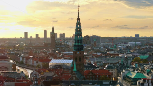 Video Aerial drone view of the Christiansborg Palace on the islet of Slotsholmen in central Copenhagen, Denmark at sunset - Starpik