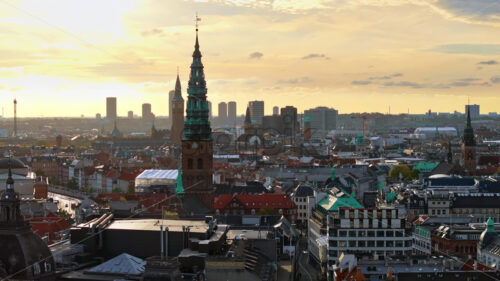 Video Aerial drone view of the Christiansborg Palace on the islet of Slotsholmen in central Copenhagen, Denmark at sunset - Starpik