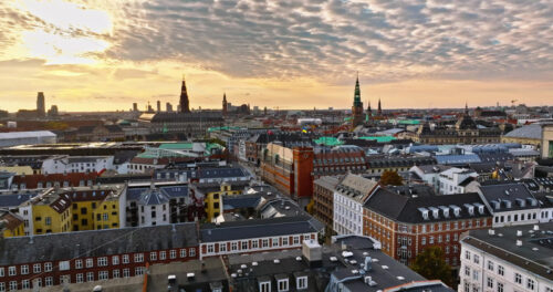 Video Aerial drone view of the Christiansborg Palace on the islet of Slotsholmen in central Copenhagen, Denmark at sunset - Starpik