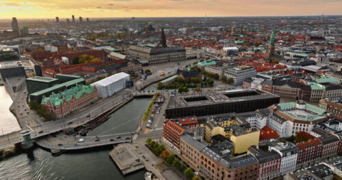 Video Aerial drone view of the Christiansborg Palace on the islet of Slotsholmen in central Copenhagen, Denmark at sunset - Starpik