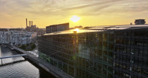 Video Aerial drone view of the Islands Brygge harbourfront area in central Copenhagen, Denmark at sunset - Starpik