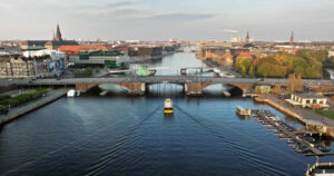 Video Aerial drone view of the Islands Brygge harbourfront area in central Copenhagen, Denmark at sunset - Starpik