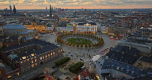 Video Aerial drone view of the Kongens Nytorv public square in Copenhagen, Denmark at night - Starpik