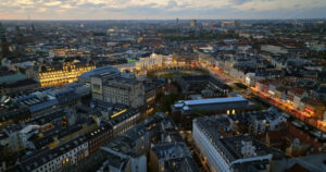 Video Aerial drone view of the Kongens Nytorv public square in Copenhagen, Denmark at night - Starpik