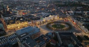 Video Aerial drone view of the Kongens Nytorv public square in Copenhagen, Denmark at night - Starpik