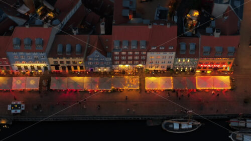 Video Aerial drone view of the Nyhavn waterfront, canal and entertainment district in Copenhagen, Denmark in the evening - Starpik