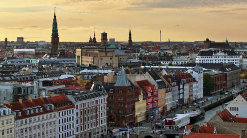 Video Aerial drone view of the Nyhavn waterfront, canal and entertainment district in Copenhagen, Denmark in the evening - Starpik