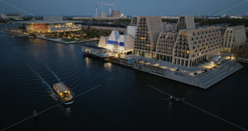 Video Aerial drone view of the Paper Island urban oasis surrounded by water in Copenhagen, Denmark at night - Starpik