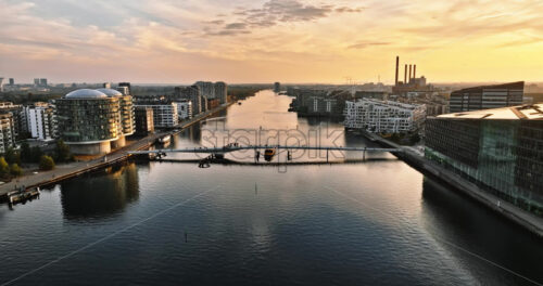 Video Aerial drone view of the Quay Bridge across the port of Copenhagen, Denmark at sunset - Starpik