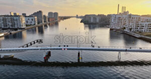 Video Aerial drone view of the Quay Bridge across the port of Copenhagen, Denmark at sunset - Starpik