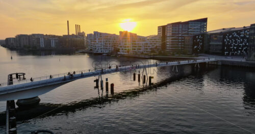 Video Aerial drone view of the Quay Bridge across the port of Copenhagen, Denmark at sunset - Starpik