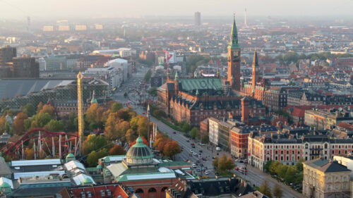 Video Aerial drone view of the Tivoli amusement park and the City Hall in Copenhagen, Denmark at sunset - Starpik