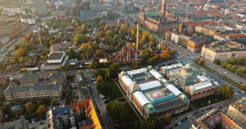 Video Aerial drone view of the Tivoli amusement park and the City Hall in Copenhagen, Denmark at sunset - Starpik