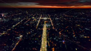 Aerial drone view of Chisinau at sunset, Moldova. View of city centre with multiple buildings, roads with traffic, illumination - Starpik