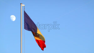 The Moldovan flag waving on a blue sky with the moon background - Starpik