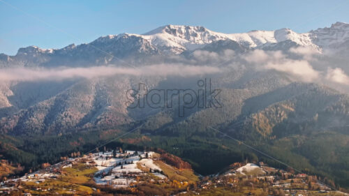 Video Aerial drone view of a little snow on the Bucegi Mountains, near Brasov, Romania - Starpik