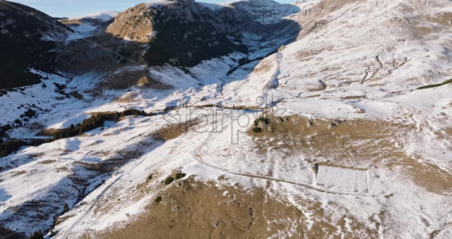 Video Aerial drone view of a little snow on the Bucegi Mountains, near Brasov, Romania - Starpik