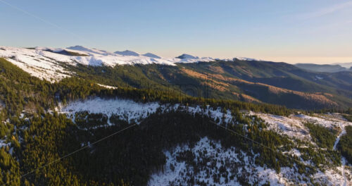 Video Aerial drone view of a little snow on the Bucegi Mountains, near Brasov, Romania - Starpik