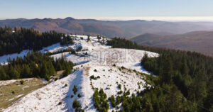 Video Aerial drone view of a little snow on the Bucegi Mountains, near Brasov, Romania - Starpik