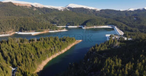 Video Aerial drone view of the Bolboci Lake in the heart of the mountains, near Brasov, Romania - Starpik