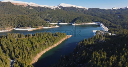 Video Aerial drone view of the Bolboci Lake in the heart of the mountains, near Brasov, Romania - Starpik