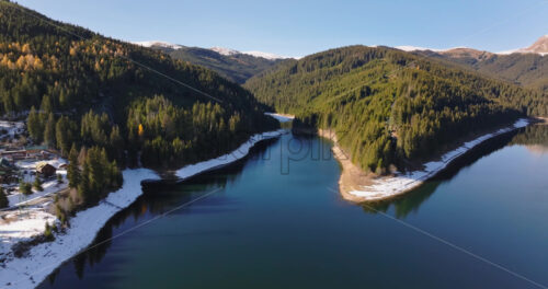 Video Aerial drone view of the Bolboci Lake in the heart of the mountains, near Brasov, Romania - Starpik