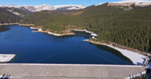 Video Aerial drone view of the Bolboci Lake in the heart of the mountains, near Brasov, Romania - Starpik