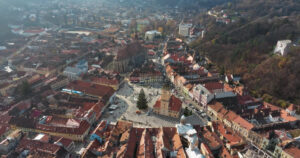 Video Aerial drone view of the Christmas tree being installed in The Council Square in the historic center of Brasov, Romania - Starpik