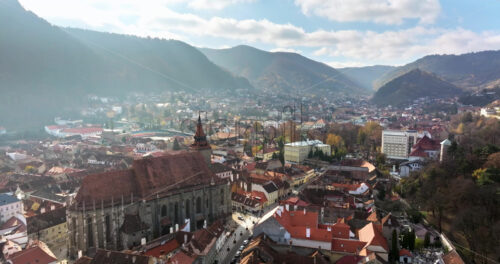 Video Aerial drone view of the city center of Brasov in south-eastern Transylvania, Romania surrounded by mountains - Starpik