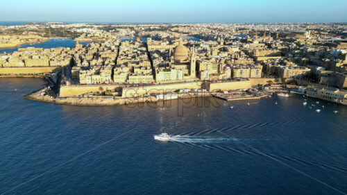 Video Aerial drone view of the walled city of Valletta, Malta, surrounded by the Mediterranean sea in daylight - Starpik