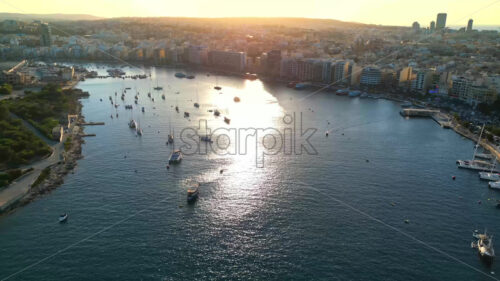 Video Aerial drone view of the walled city of Valletta, Malta, surrounded by the Mediterranean sea in daylight - Starpik