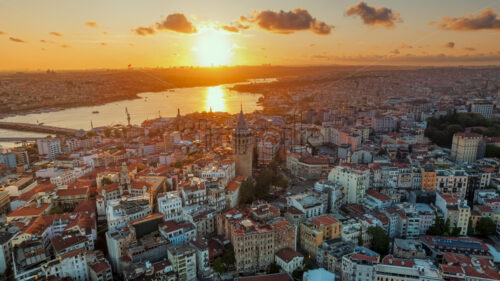 8K Video Aerial drone hyperlapse view of Istanbul at sunset, Turkey. Multiple residential buildings around the Galata tower, nightlights, Golden Horn waterway on the background, Royalty Free Stock footage - Starpik