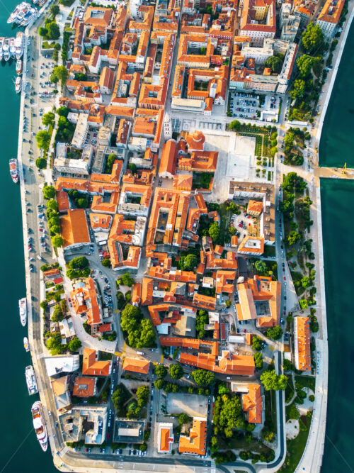 Aerial drone view of Zadar at sunset, Croatia. Historical city centre with old buildings, narrow streets, water channels and Adriatic sea coast - Starpik