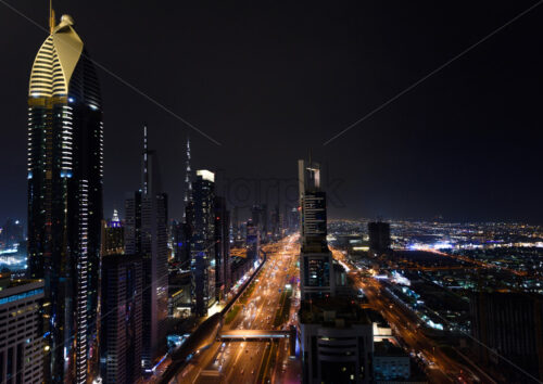 Aerial view on downtown Dubai, UAE with highways and skyscrapers. Scenic nighttime skyline - Starpik