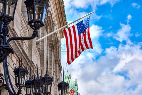 American flags at a classic court building with blue cloudy sky on background. Boston, Massachusetts - Starpik