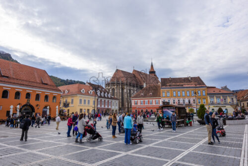 BRASOV, ROMANIA – OCTOBER 27, 2018: Historical architecture buildings in the old city square. People exploring local beauties - Starpik