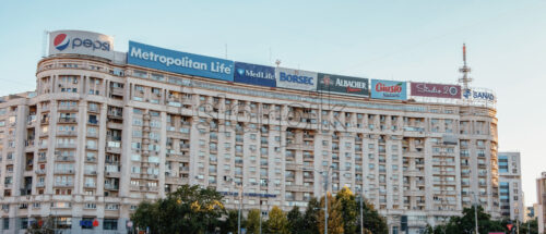 BUCHAREST, ROMANIA – OCTOBER 10, 2018: Cinematic wide view to a block of flats in Victoria Square center in Romania. Clear sky with no clouds. Big corporation ads on the building - Starpik