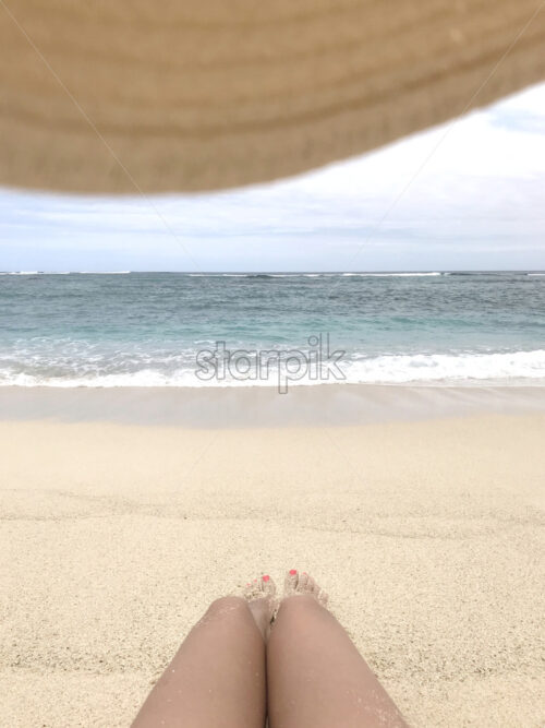 Beautiful daylight view from beach line to blue sea and waves, white sands. Grand Port District, Mauritius island, composition with woman feet and red nails - Starpik